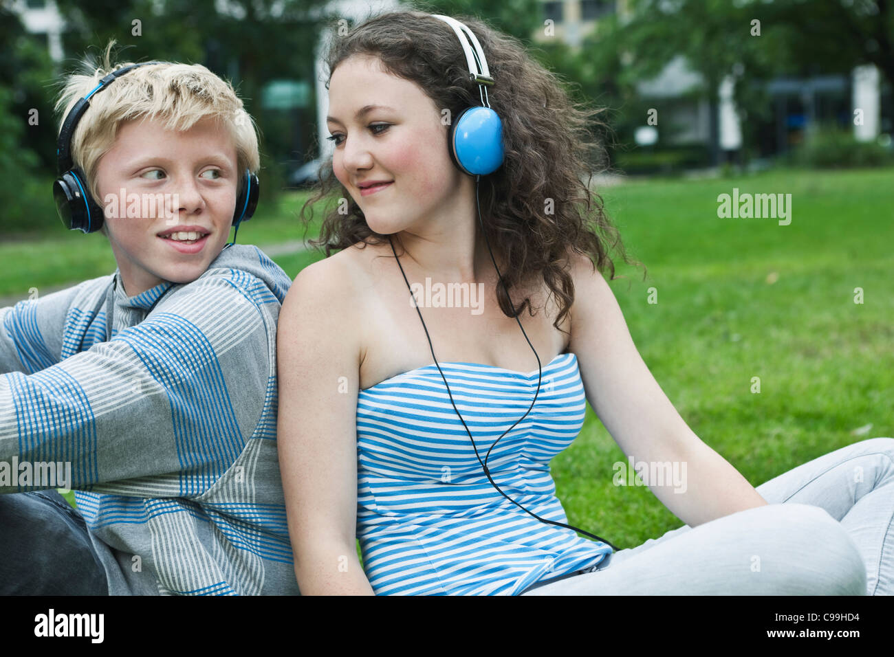 Teenagers listening mp3 park hi-res stock photography and images - Alamy