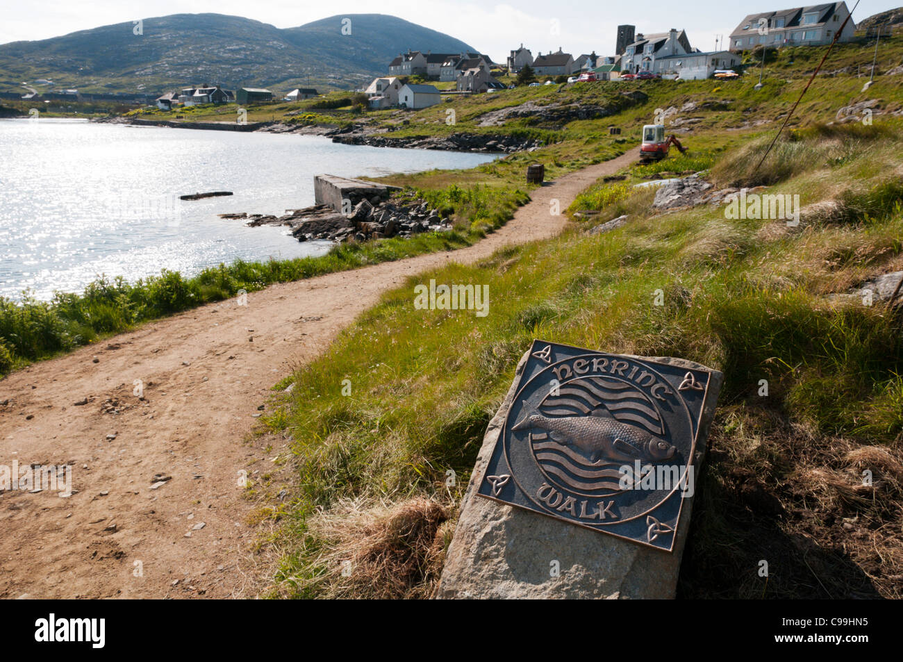 A sign marks the guided Herring Walk around the harbour at Castlebay on the Isle of Barra in the Outer Hebrides Stock Photo