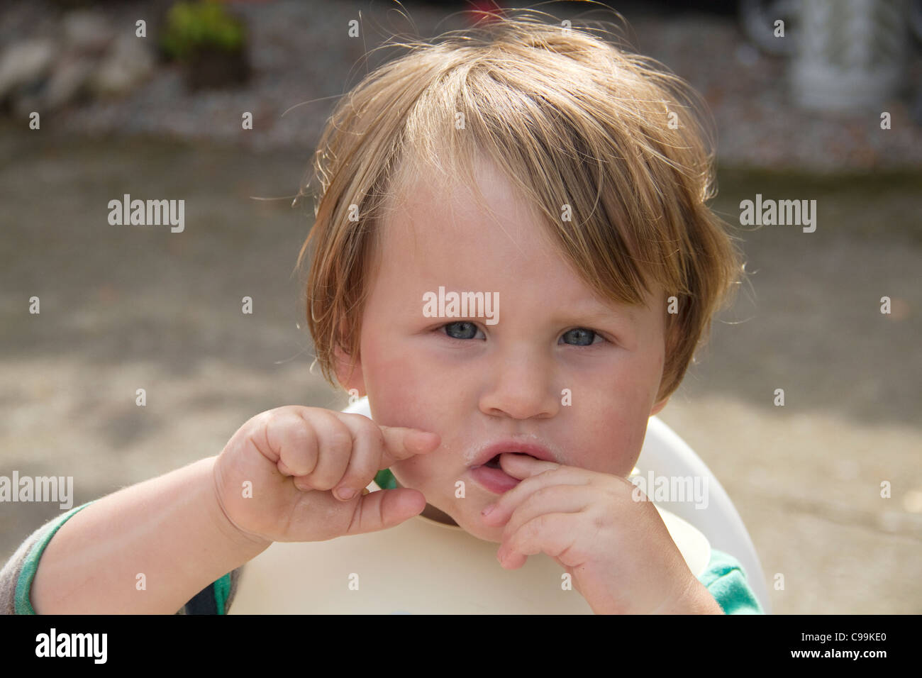 Toddler looking bemused after food Stock Photo