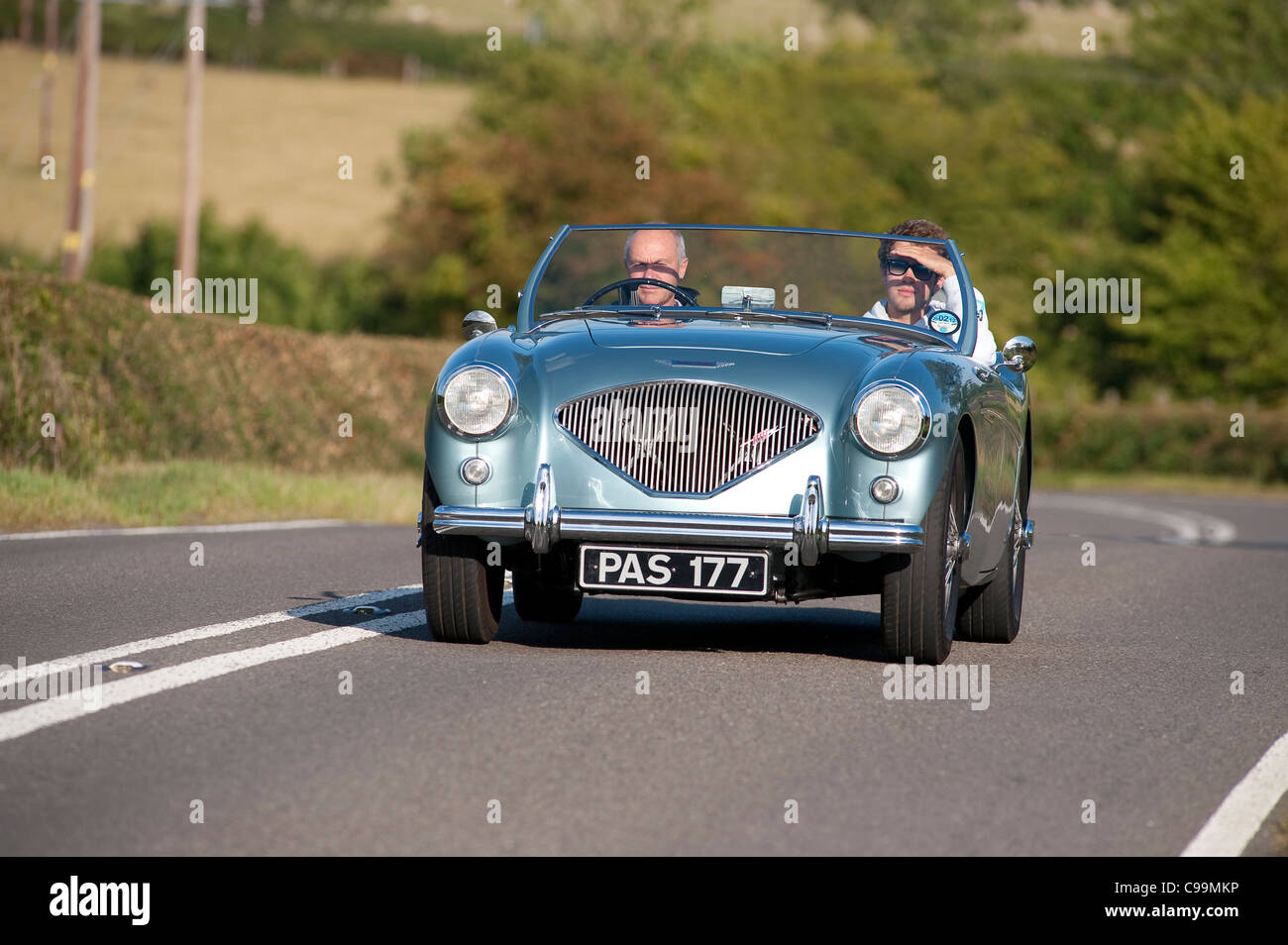 1950's Austin-Healey 100 car being driven through rural England in the summertime. Stock Photo