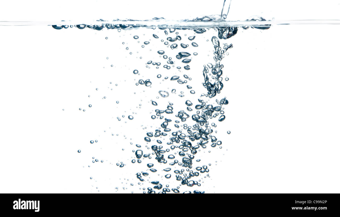 Bubbles as object is dropped into water tank Stock Photo Alamy