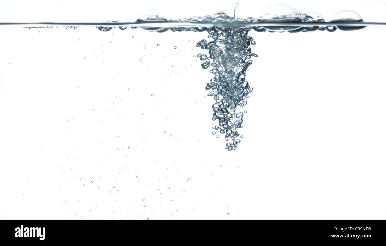 Side view of a small object being dropped into a tank of water Stock Photo