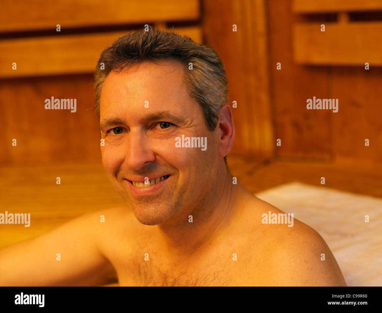 Germany, Hamburg, Mature man in sauna, smiling, portrait Stock Photo ...