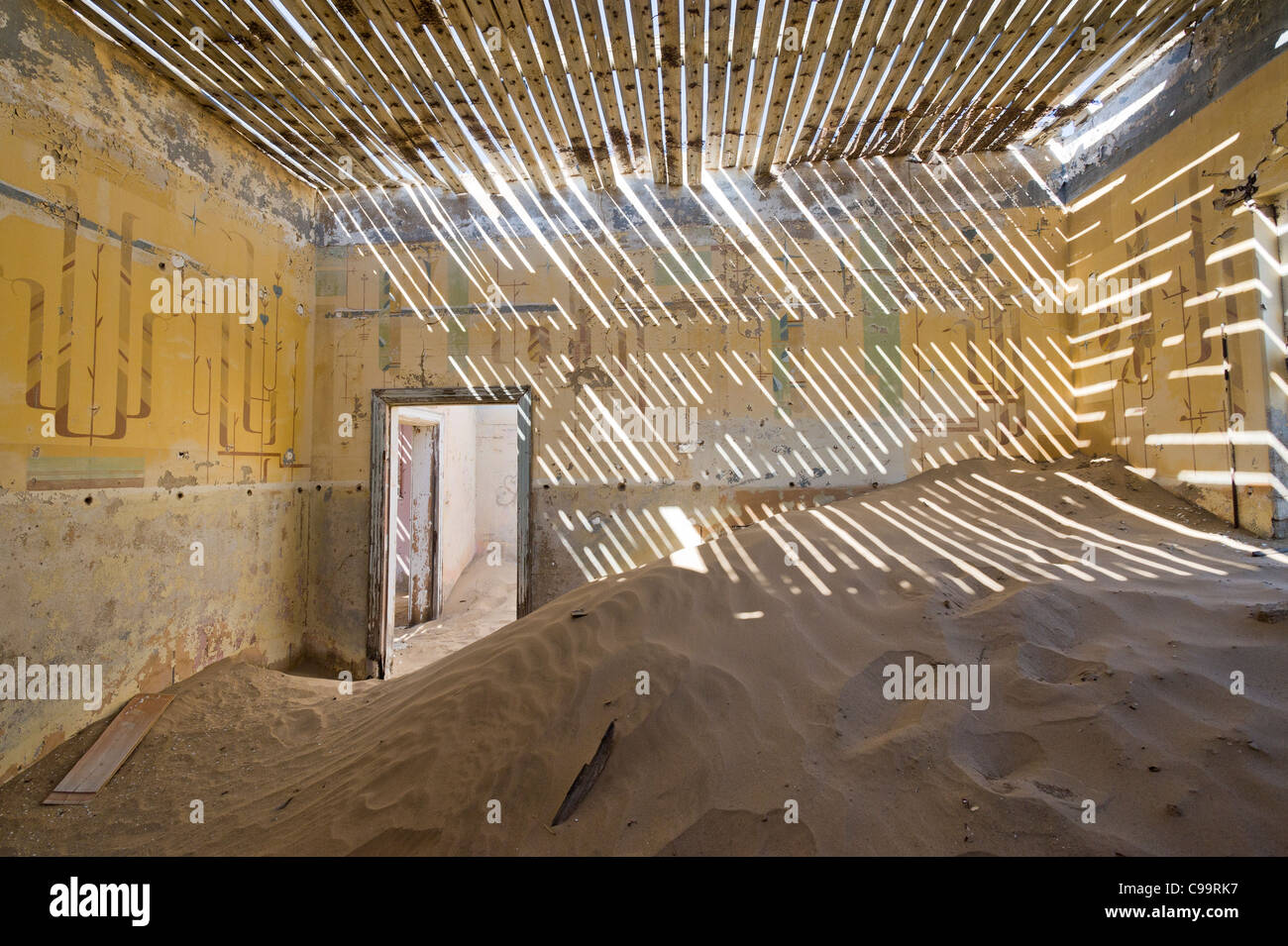 Room filled with sand in an abandoned house in Kolamanskop a former diamond mine in Namibia Stock Photo