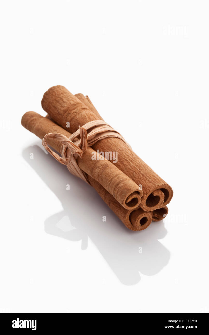 Bundled cinnamon sticks on white background Stock Photo