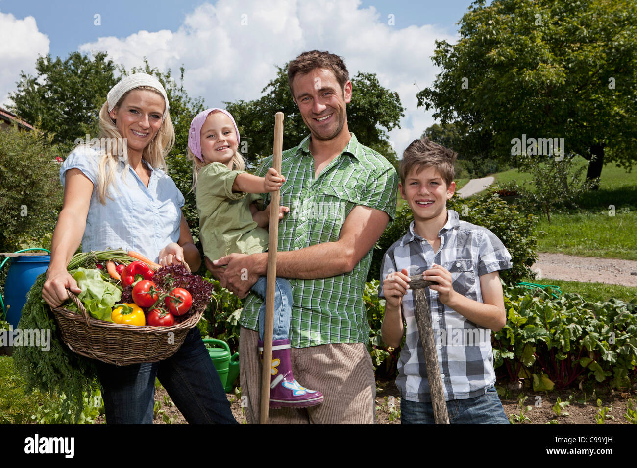 Germany, Bavaria, Altenthann, Family gardening together in garden Stock Photo