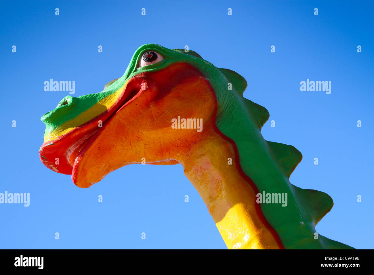Colourful model dragon head at playpark Stock Photo
