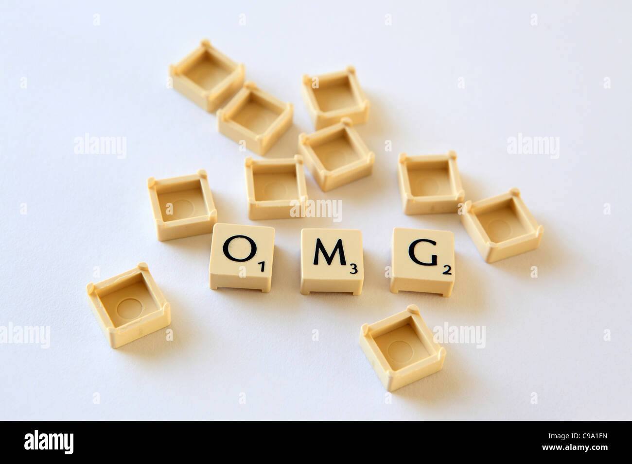 "OMG" spelled out in Scrabble letter tiles squares, sland txt texting chat speak, studio