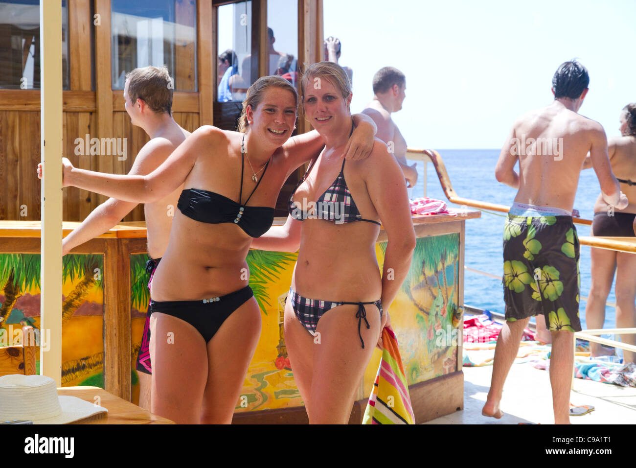 Attractive beautiful Dutch girls in swimsuit bikini posing smiling on board of tourist yacht Mallorca Majorca Balearic Spain Stock Photo