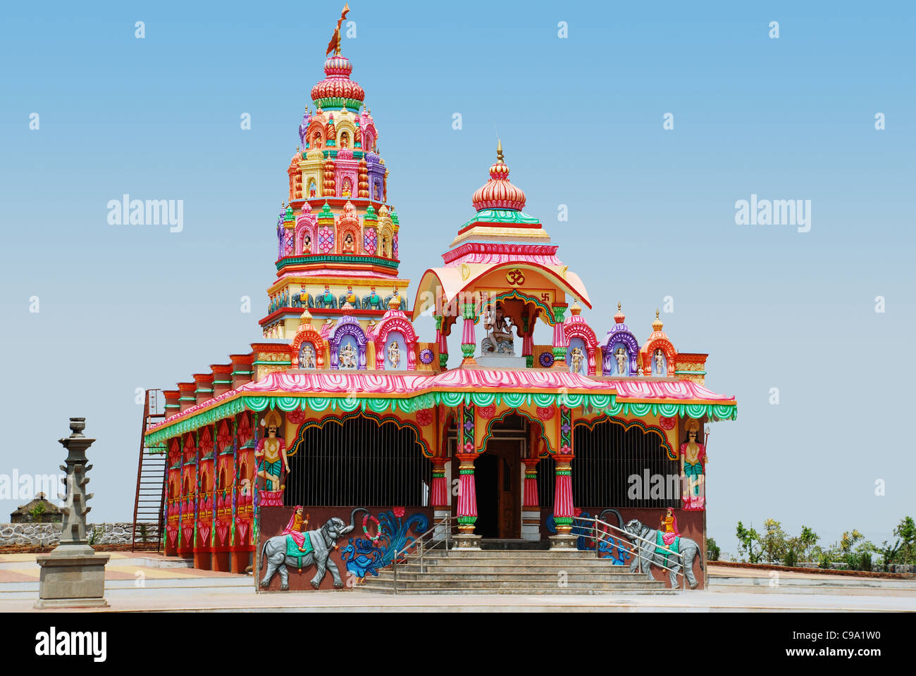 View of a vibrantly painted Hindu Temple dedicated to Lord Shiva, Saswad Village, Dist. Pune, Maharashtra State, India. Stock Photo