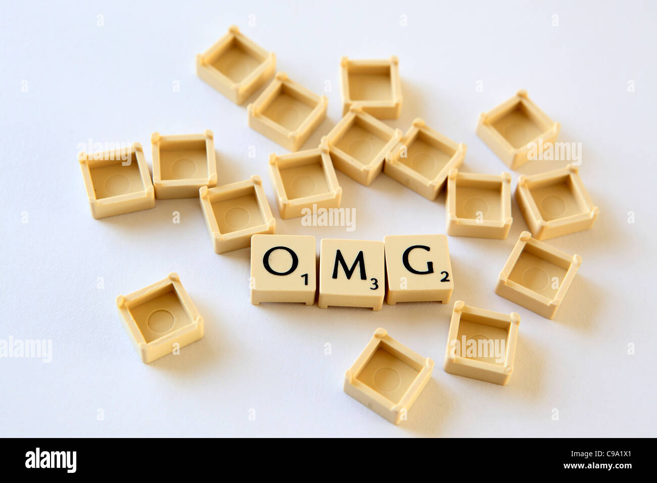 "OMG" spelled out in Scrabble letter tiles squares, sland txt texting chat speak, studio