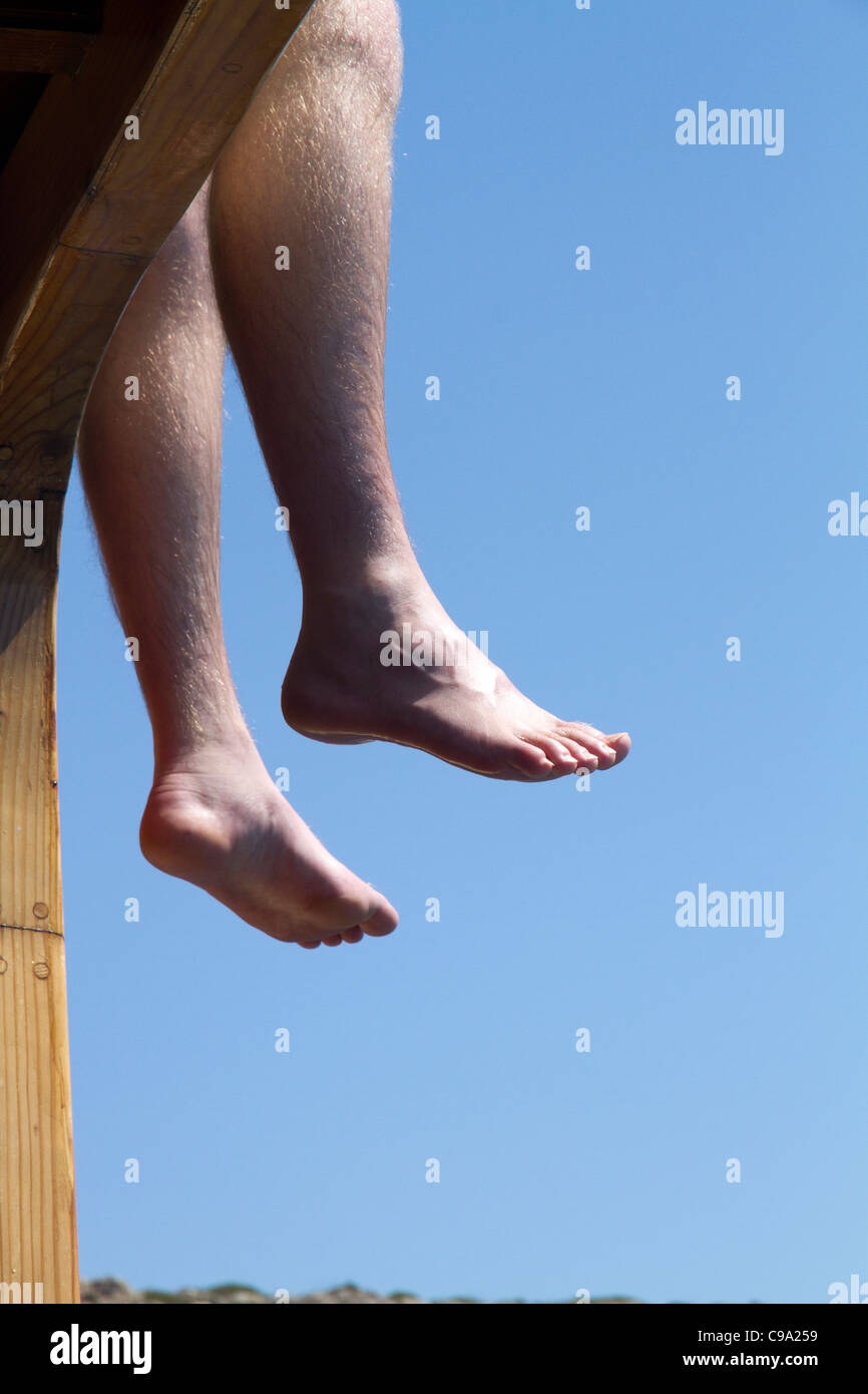 Person legs hanging dangling on touristic charter boat Stock Photo - Alamy