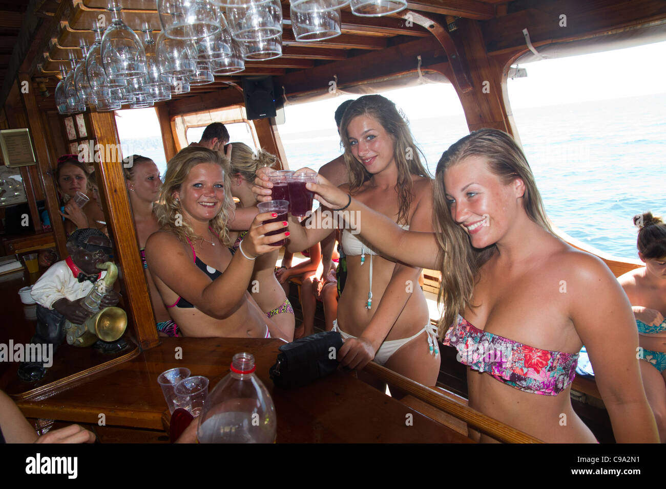 Attractive beautiful Dutch girls in swimsuit bikini toasting sangria on  board of tourist yacht Mallorca Majorca Balearic Spain Stock Photo - Alamy