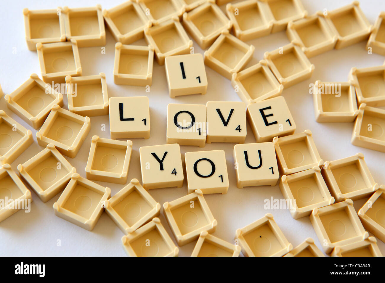 Scrabble tiles / squares spellout "I LOVE YOU", white background studio photograph Stock Photo