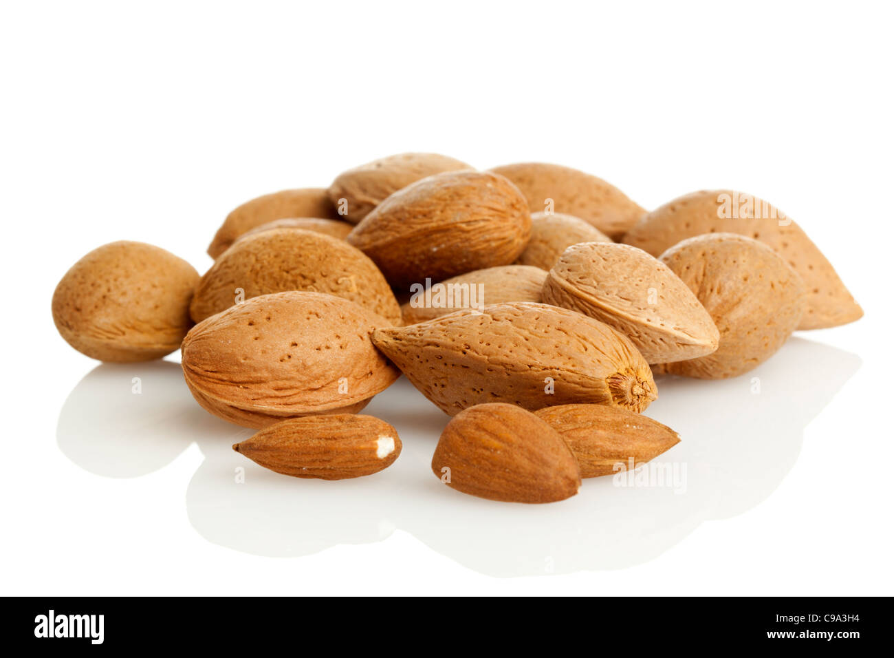 almonds with and without nutshells on white background Stock Photo - Alamy