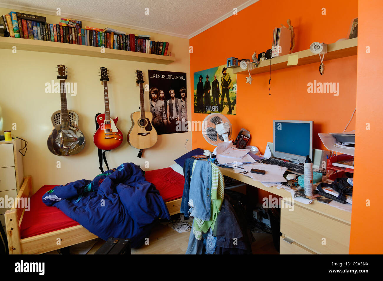 An untidy and brightly coloured teenager's bedroom. Stock Photo