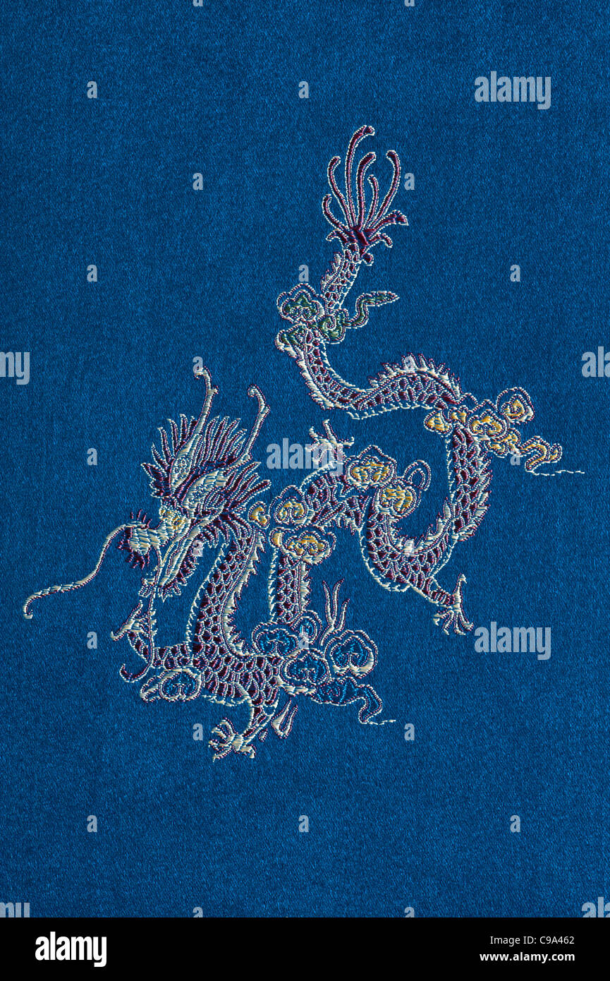 Chinese dragon embroidered on a blue silk Stock Photo - Alamy