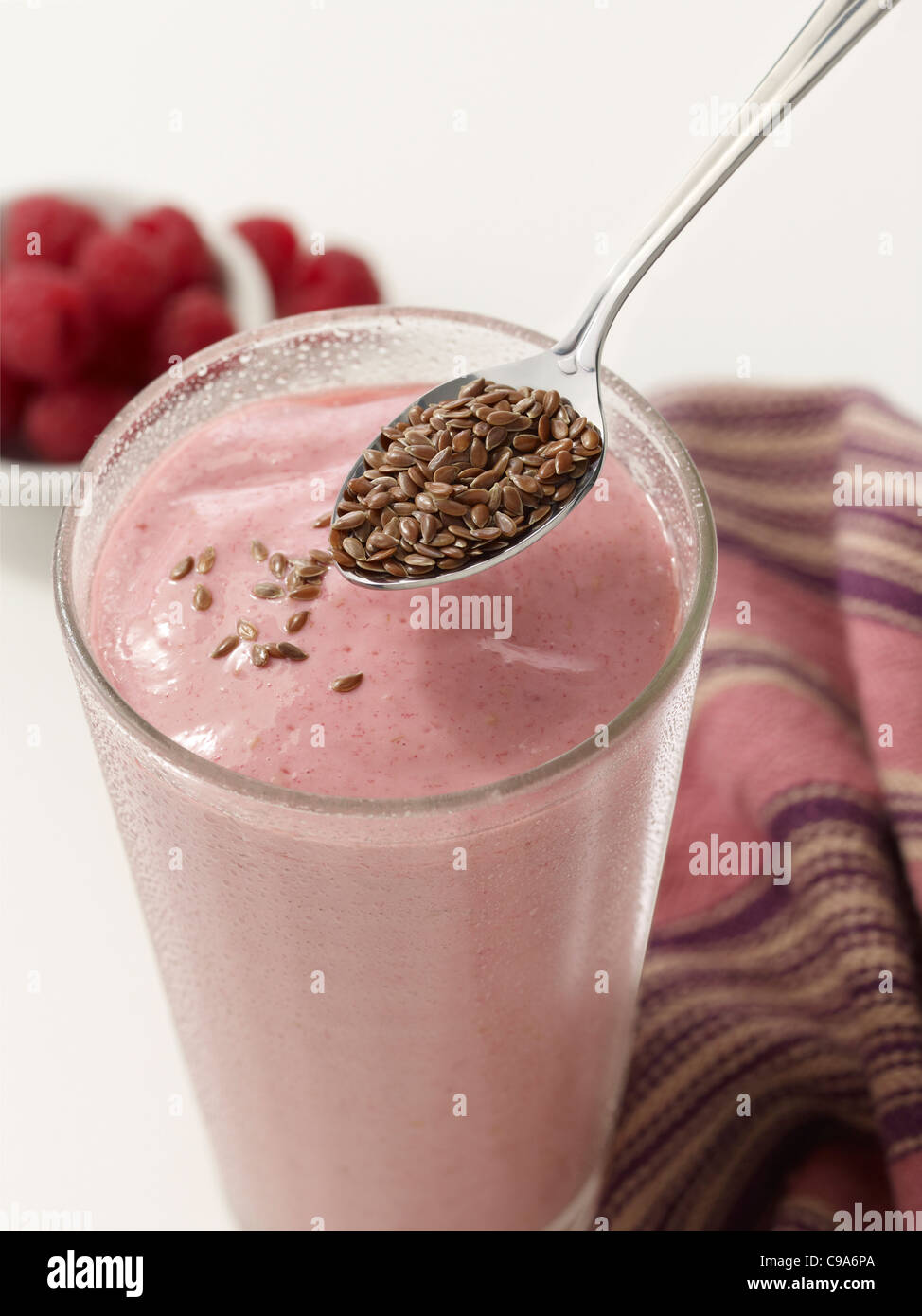 Strawberry smoothie with flax seed on a spoon Stock Photo
