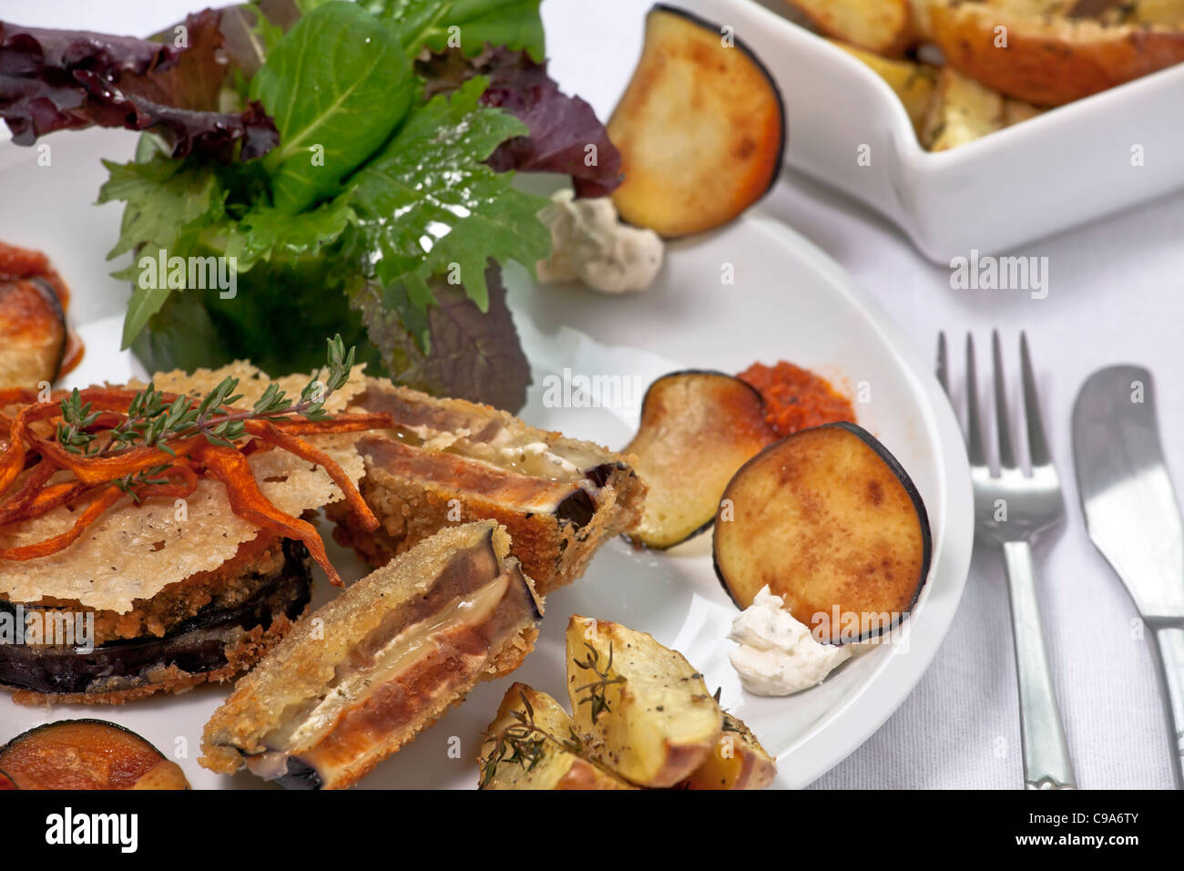 Eggplant Cordon Bleu stuffed with Swiss cheese and red pesto, served with thyme potatoes  Stock Photo