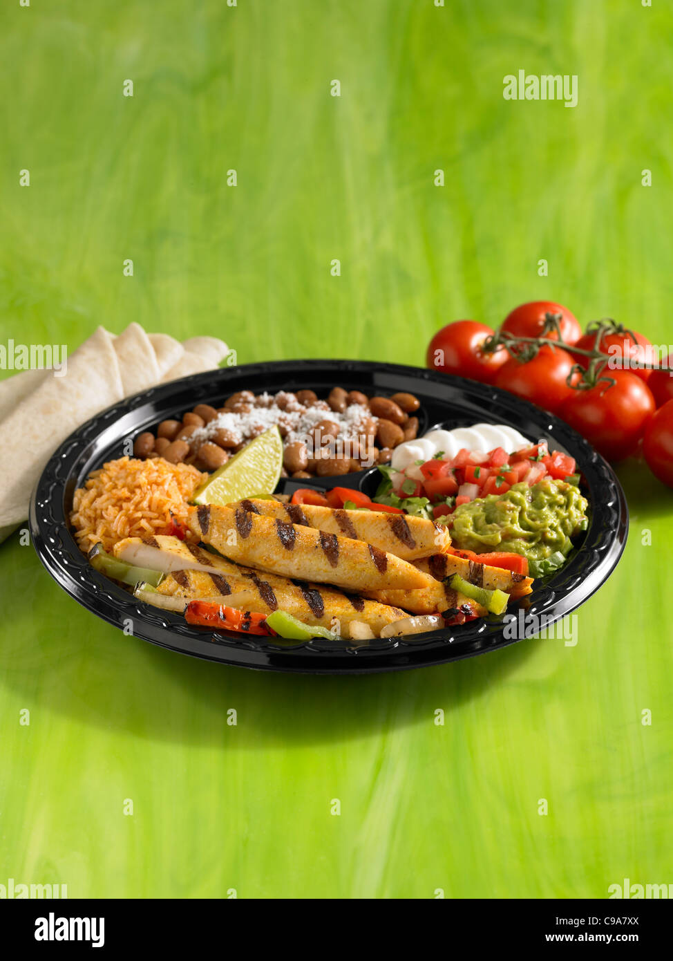 Grilled chicken fajitas over vegetables with pinto beans, Spanish rice