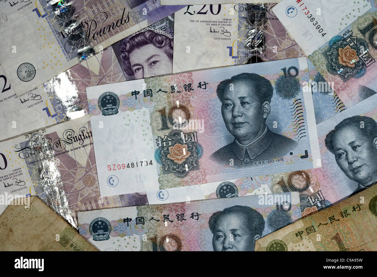 chinese renminbi rmb on top of british pounds banknotes Stock Photo