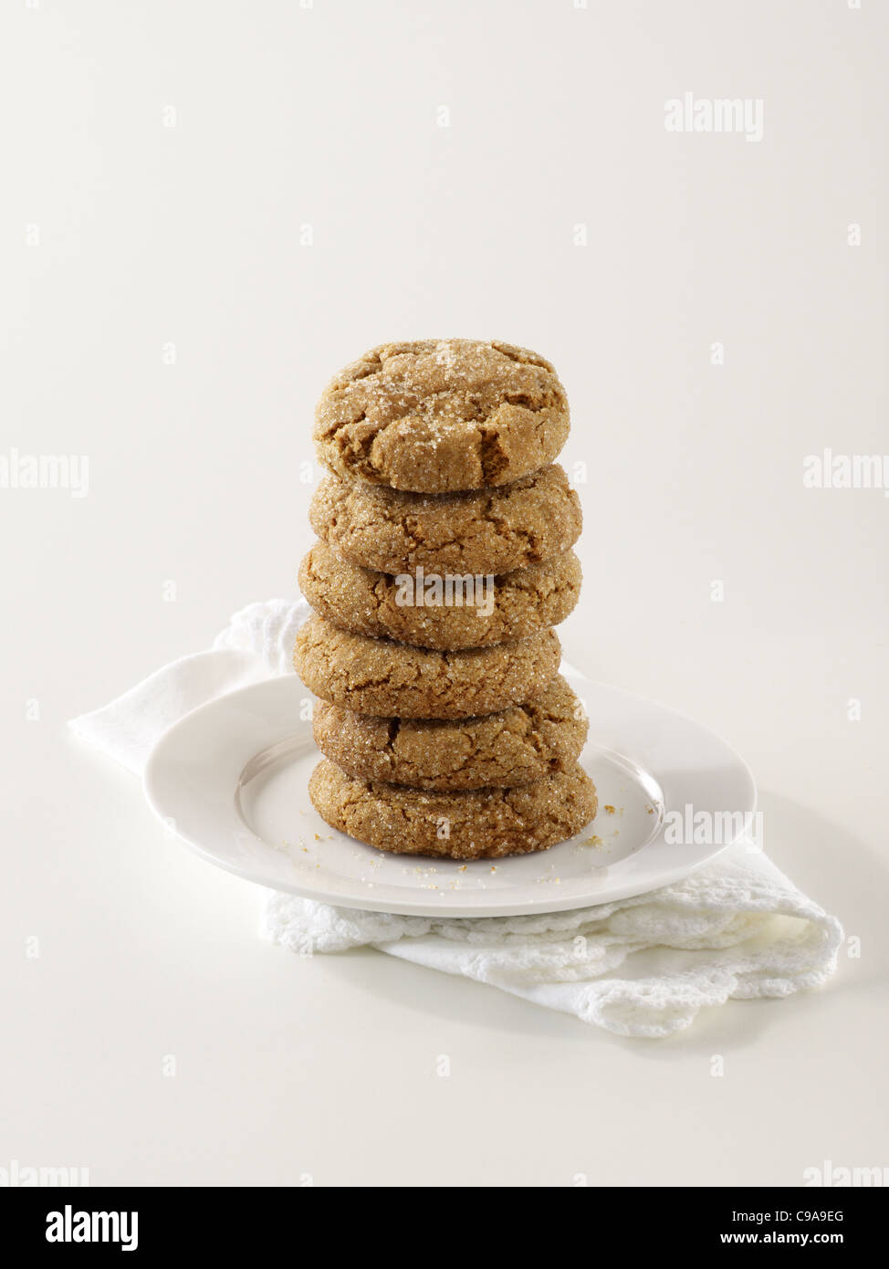 A stack of ginger snap cookies on a white plate Stock Photo