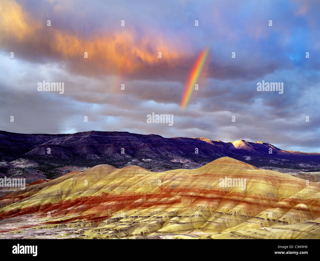 Rainbow and storm clouds. Painted Hills, John Day Fossil Beds National Monument, Oregon Stock Photo