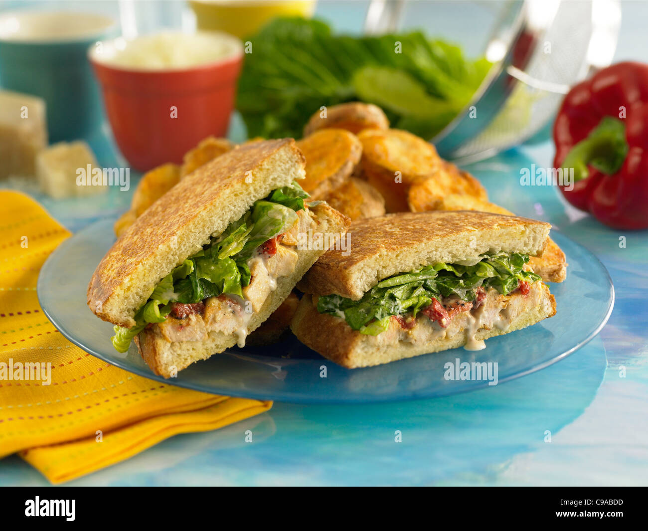Gourmet chicken sandwich with leafy greens on grilled sourdough bread