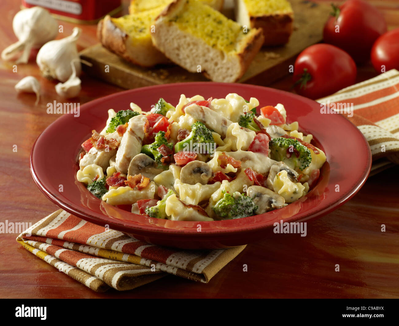 A bowl of creamy chicken Fettuccine Alfredo served with garlic bread