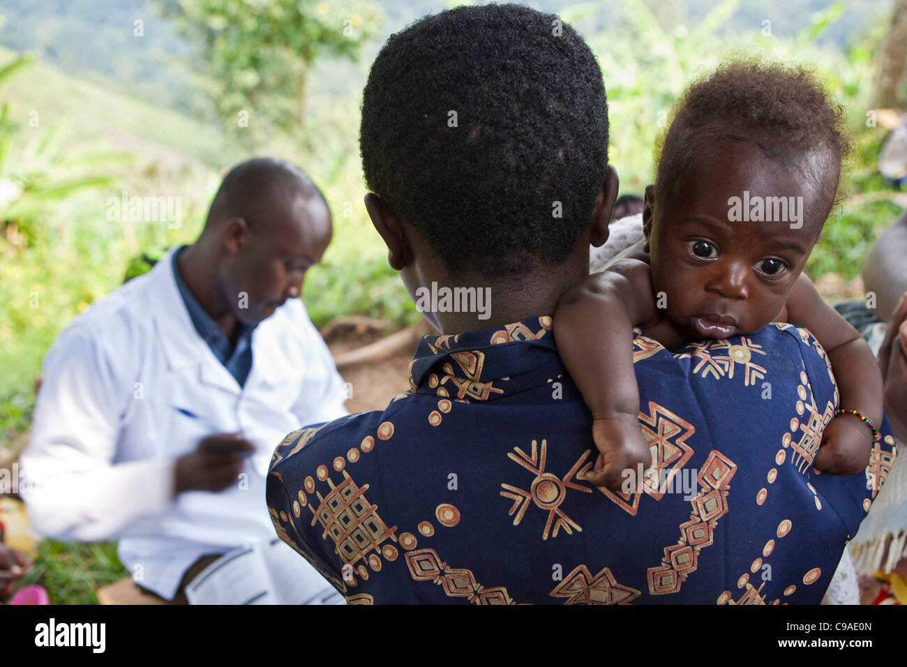 Women gather for health checks and to vaccinate their children. Bwindi Community hospital medical out reach clinic, Uganda. Stock Photo