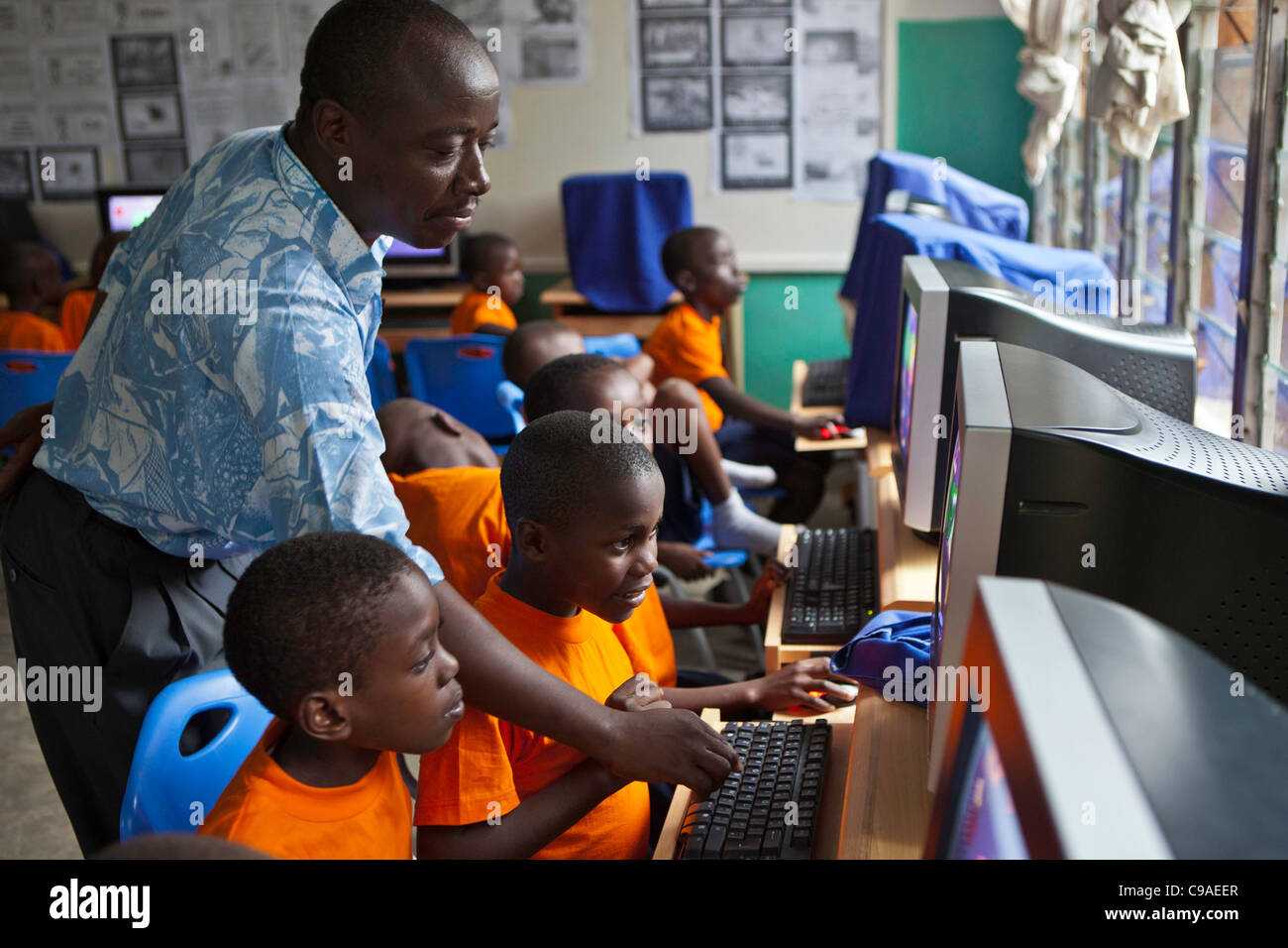 Computer lesson at  kindergarten of the Wema Centre, Mombassa, Kenya. Wema provide a rehabilitation program for street children. Stock Photo