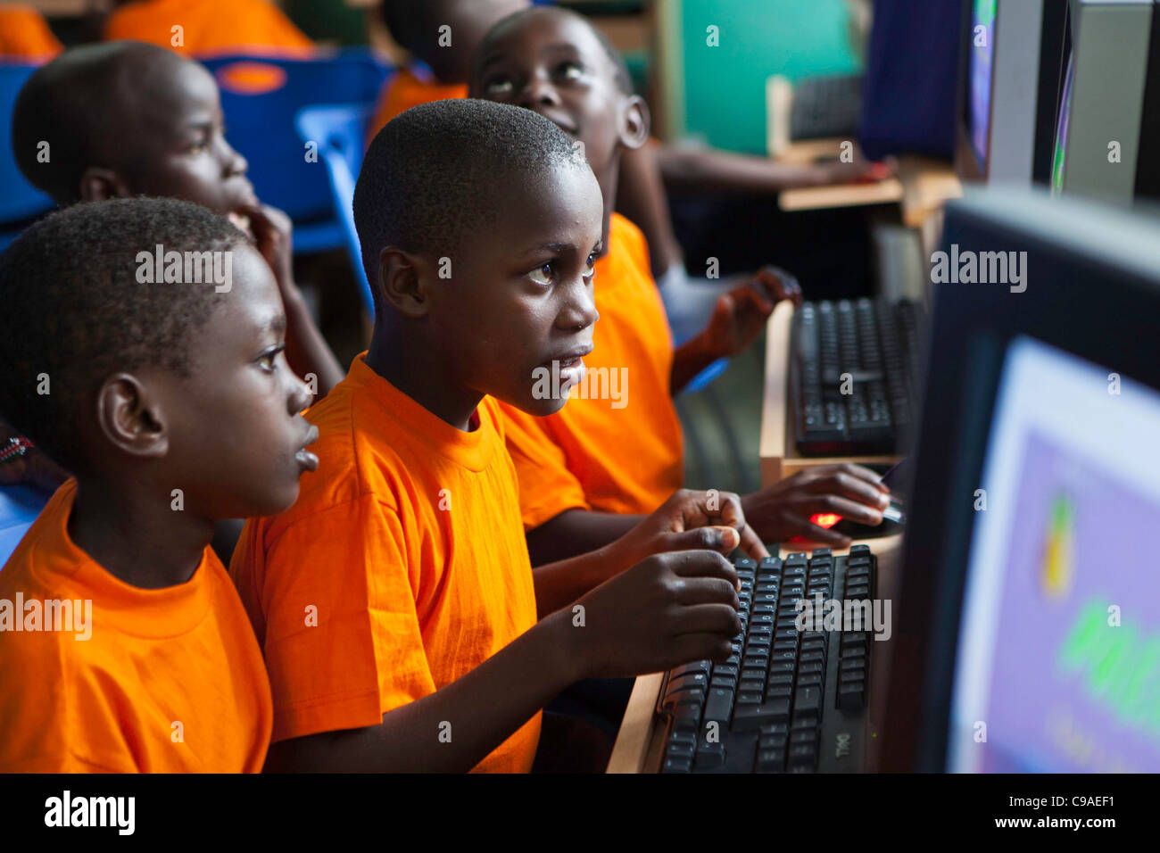 Computer lesson at  kindergarten of the Wema Centre, Mombassa, Kenya. Wema provide a rehabilitation program for street children. Stock Photo