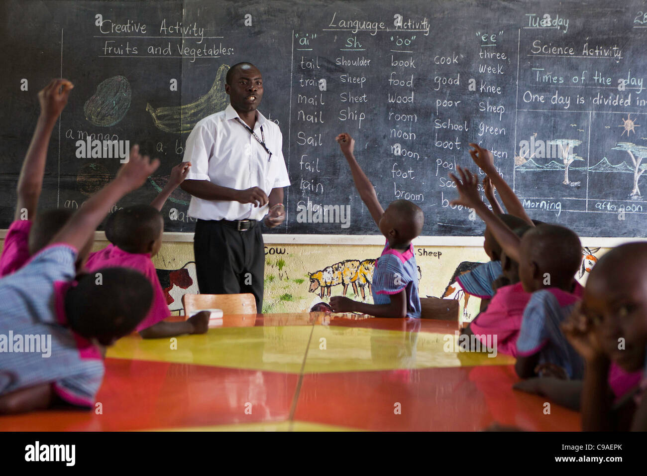 Teacher at the kindergarten school during lessons at the Wema Centre, Mombassa, Kenya. Stock Photo