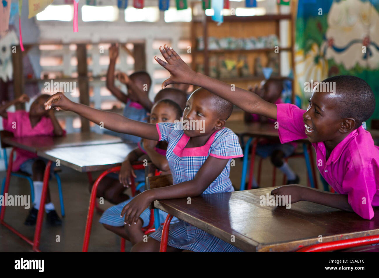 Children attend the kindergarten school learn to read and write at the Wema Centre, Mombassa, Kenya. Stock Photo