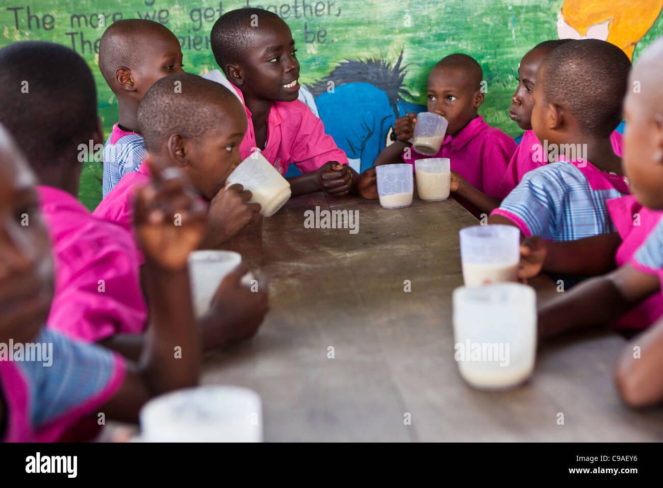 Children from the Wema centre in Mombassa, Kenya enjoy breakfast. Wema provide a rehabilitation program for street children. Stock Photo