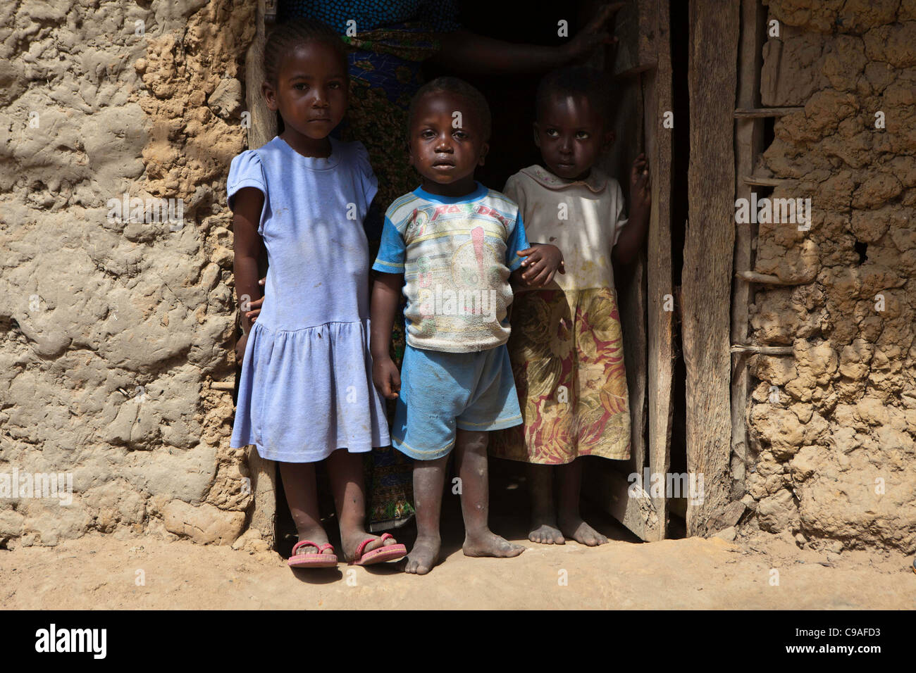 Family outside their home near Mombasa, Kenya. The children are supported by Wema an NGO supporting street children. Stock Photo