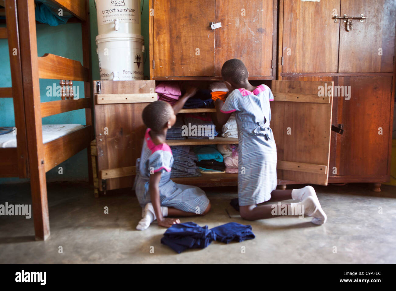 Mary and her sister in their dormitory at the Wema centre for girls. Wema is an NGO organisation supporting vulnerable children. Stock Photo