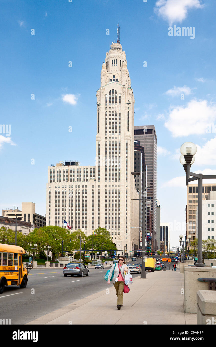 Woman walks across the Scioto River on the Broad Street Bridge in