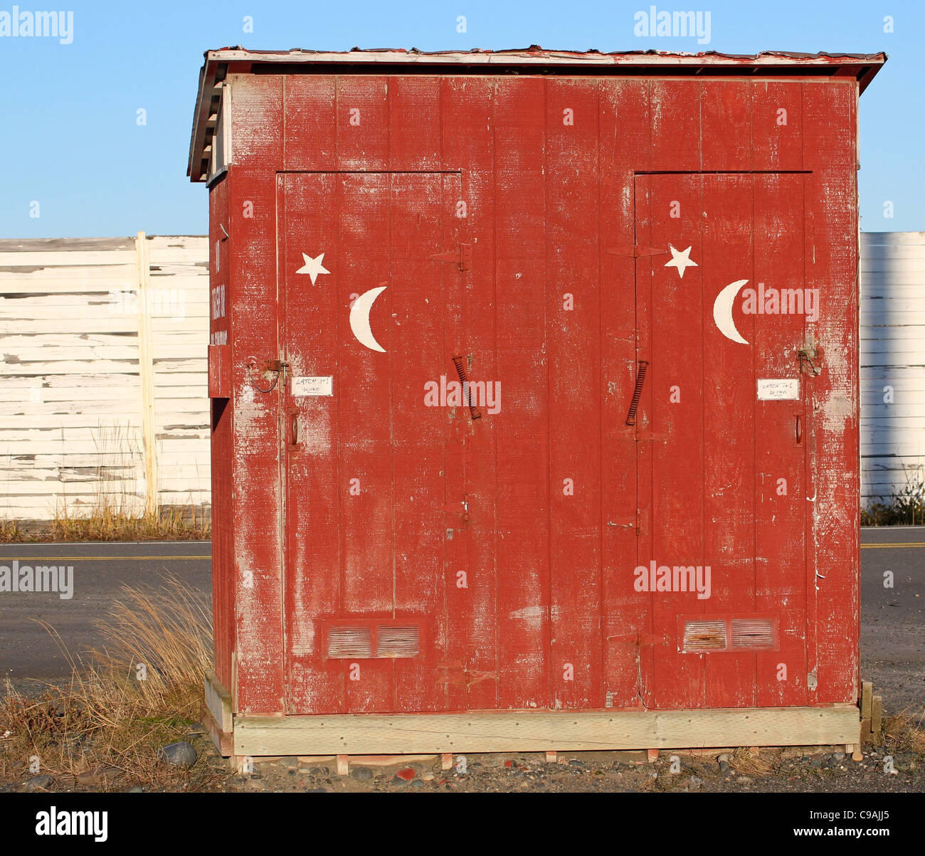 Rustic Public Restroom Building With Moon And Stars Painted On The