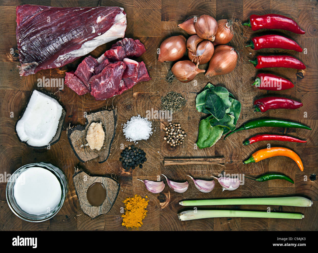 Raw Ingredients for Beef Curry on Wooden Chopping Board Stock Photo
