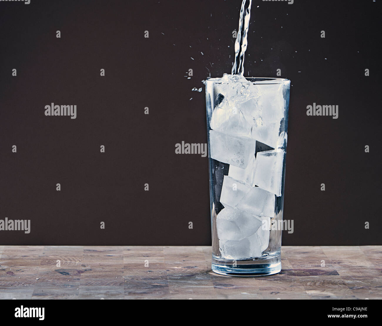 Pouring Water into Glass Full of Ice Cubes Stock Photo Alamy