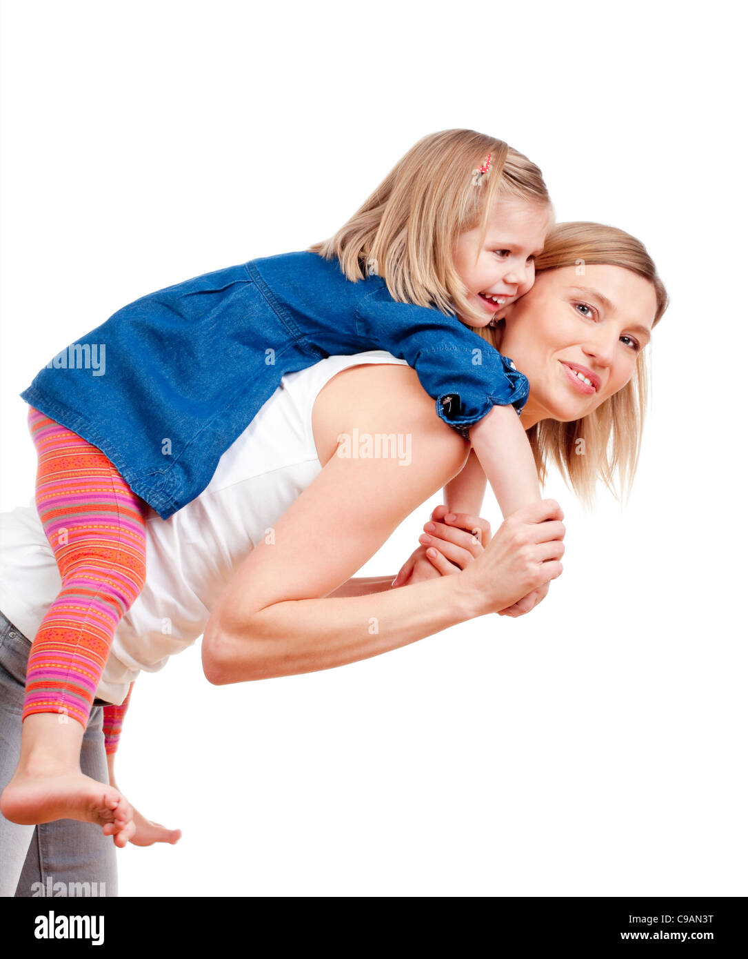 happy mother giving her daughter piggy back ride - isolated on white Stock Photo
