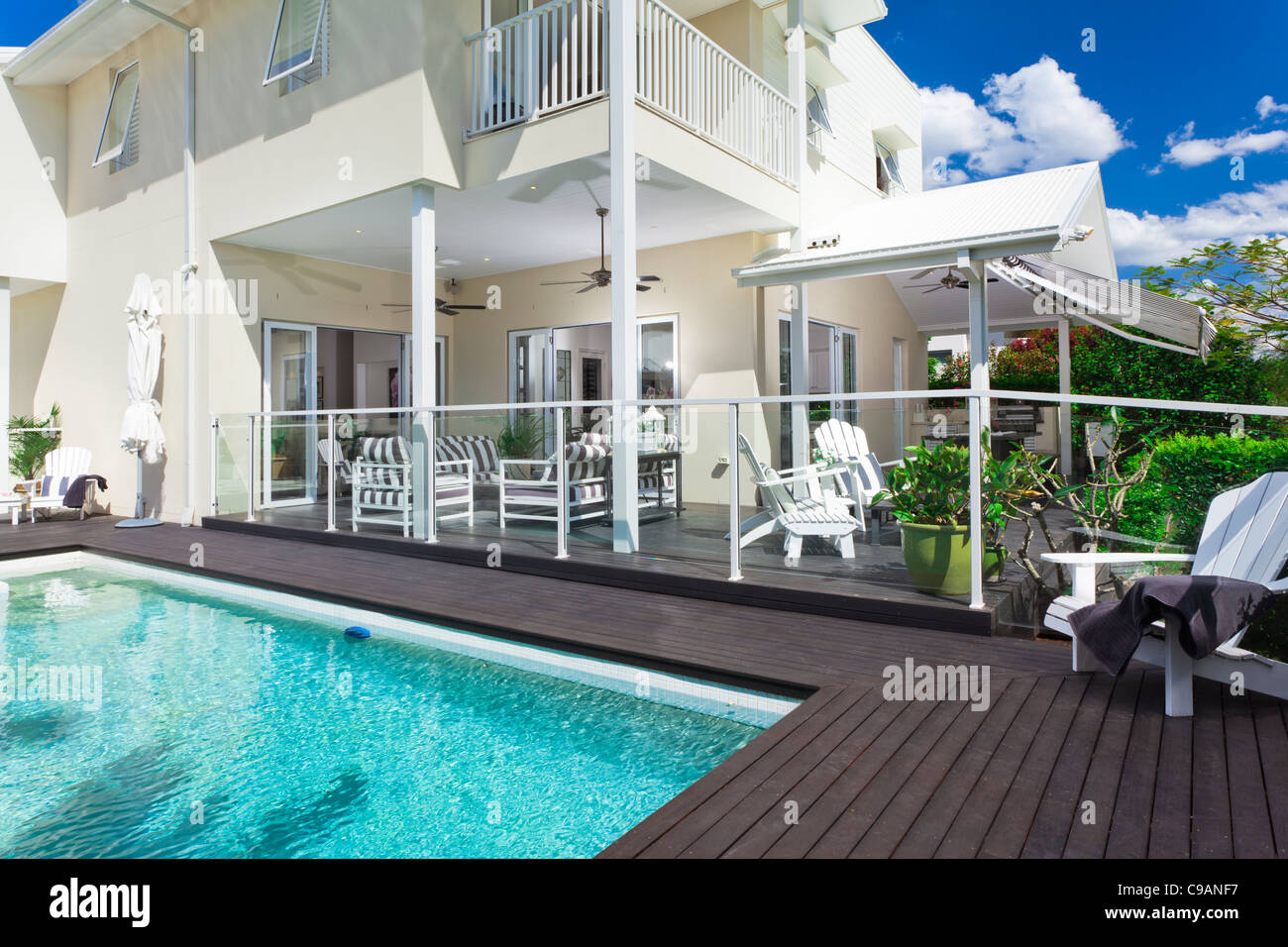 Stylish swimming pool with covered outdoor entertaining area Stock