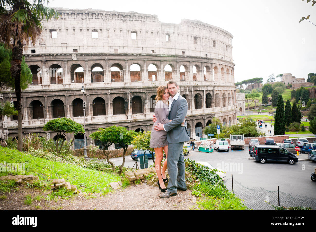 Couple in front of the Roman Colosseum Stock Photo