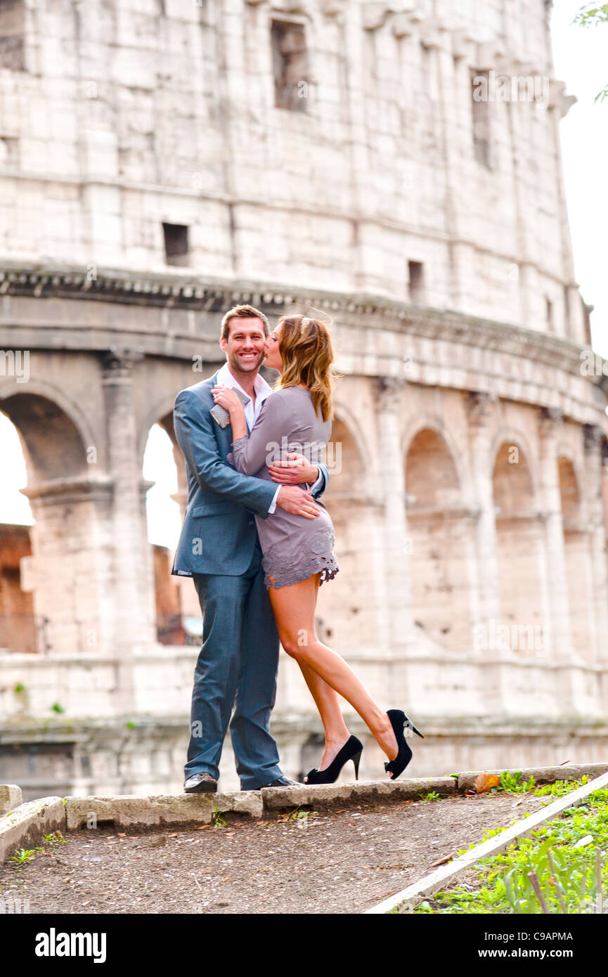Couple in front of the Roman Colosseum Stock Photo