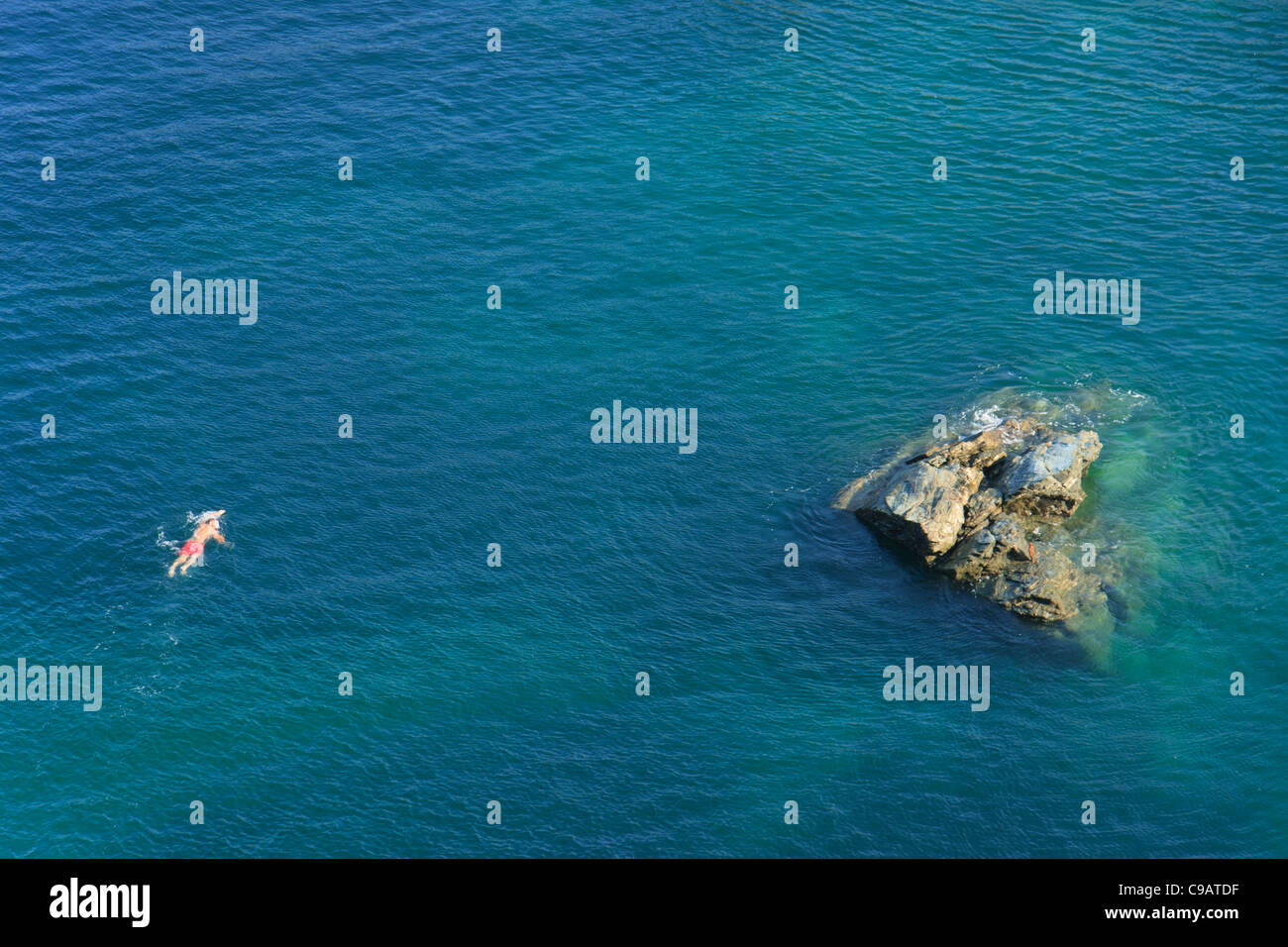 Single swimmer in the Celtic Sea on the Tintagel coast Stock Photo