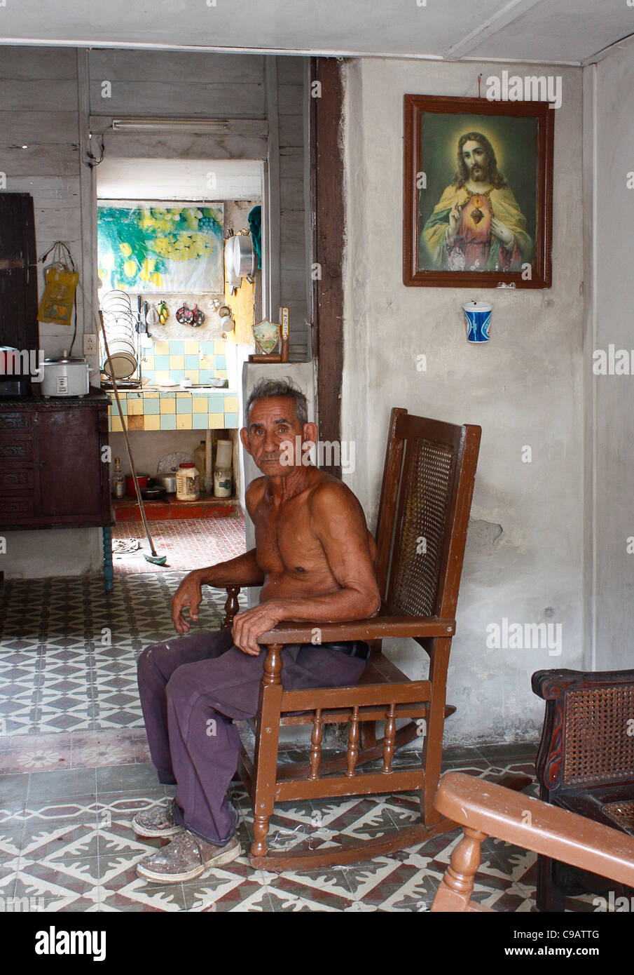 elderly man in rocking chair at his modest house in Cardenas, Cuba