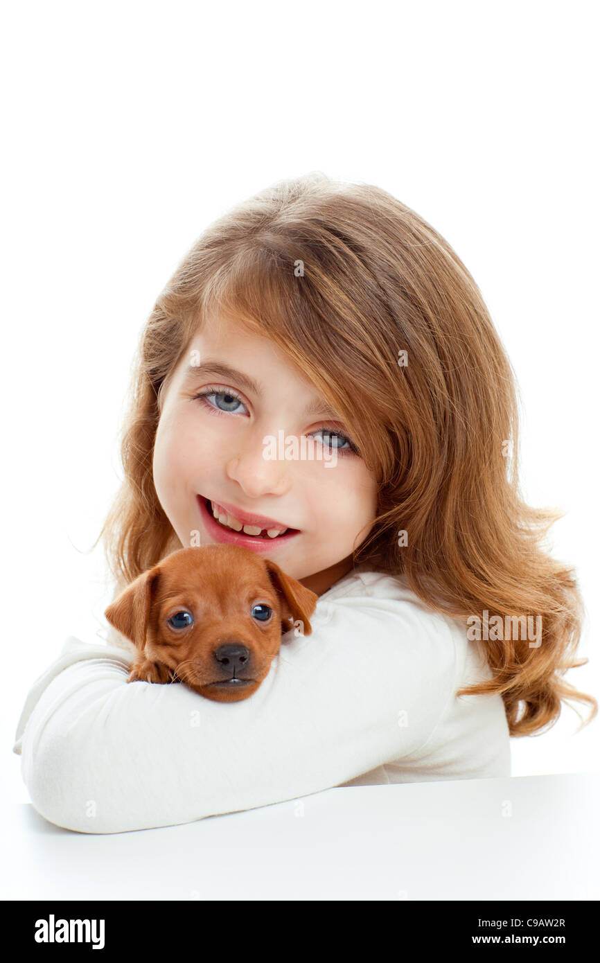 Brunette kid girl with puppy dog mascot mini pinscher on white ...