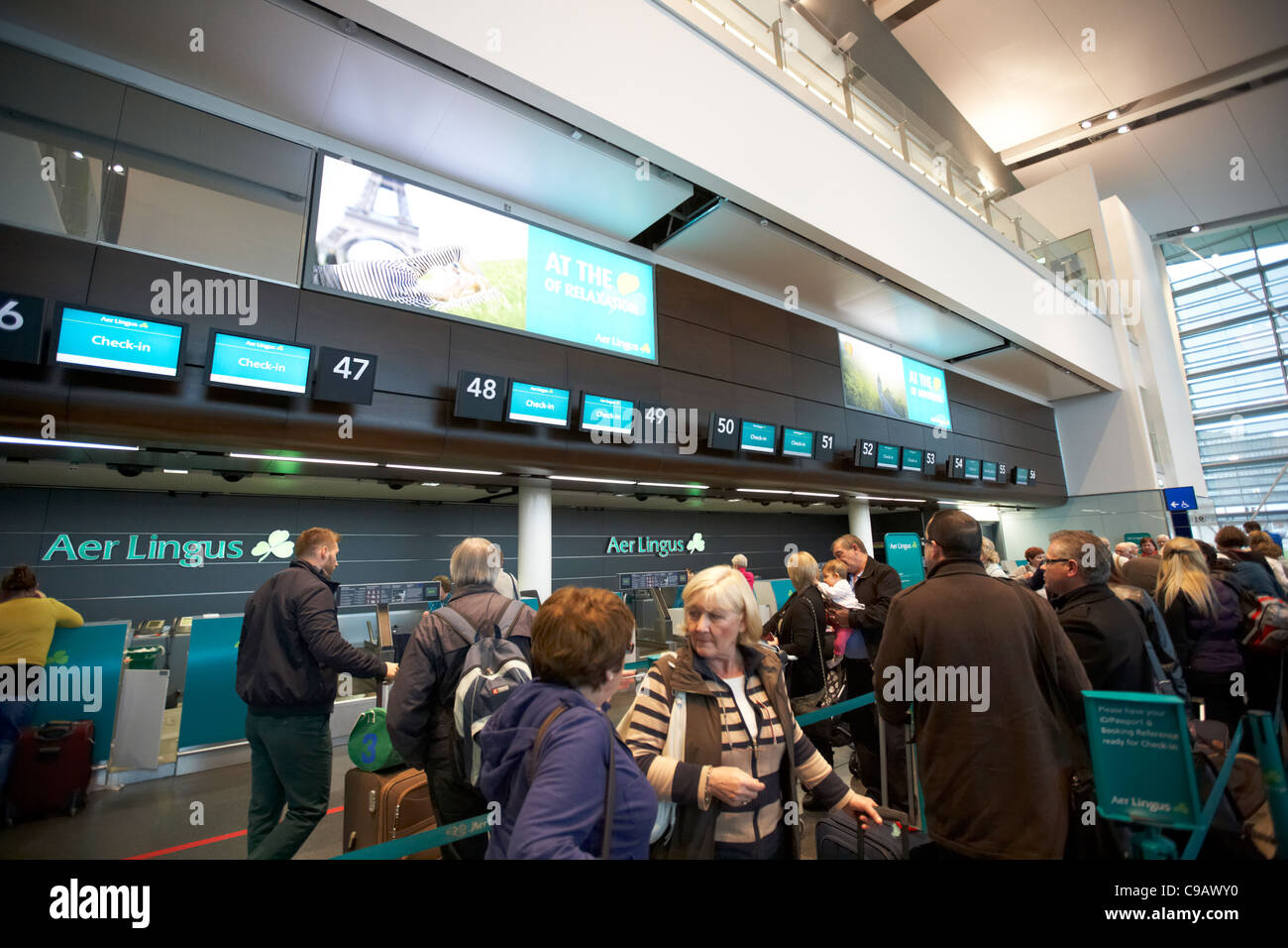 passengers queue at the aer lingus check in desks terminal 2 dublin international airport republic of ireland Stock Photo