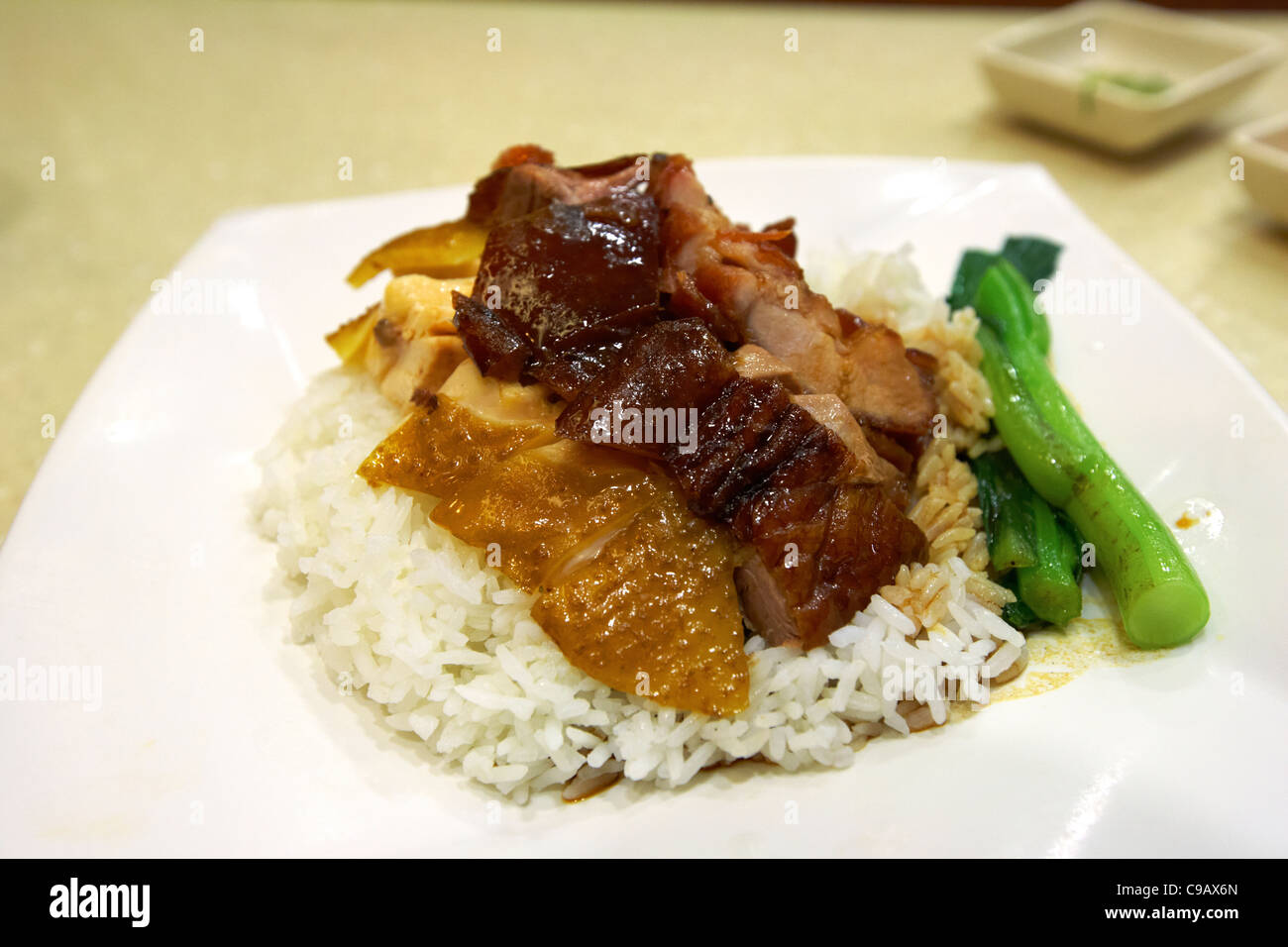 mixed roast meats including goose chicken and pork on rice in hong kong sar china Stock Photo